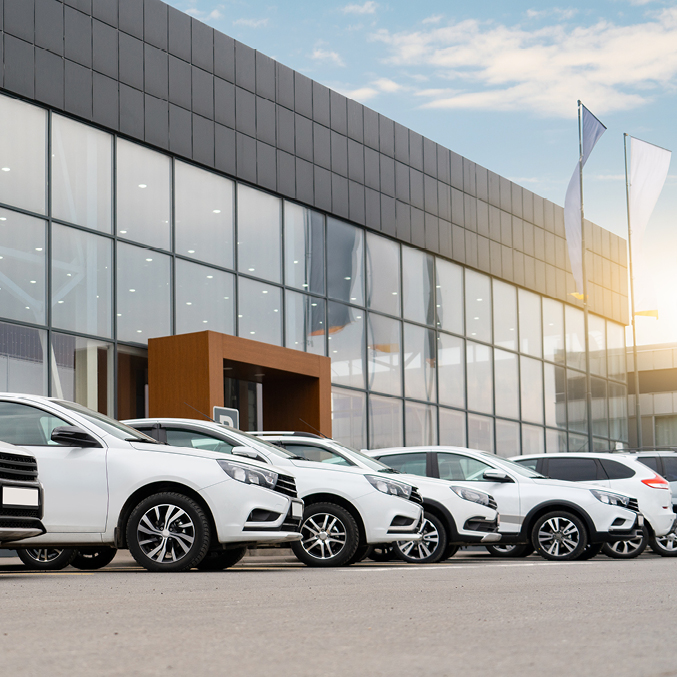 Car dealer forecourt with numerous vehicles
