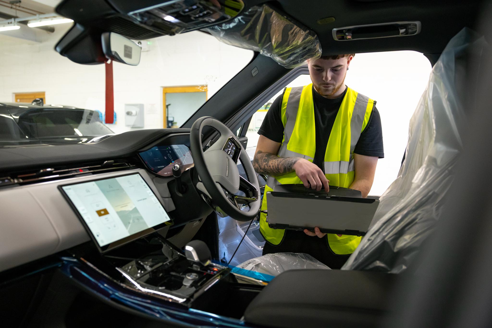 Cox engineer inspecting car