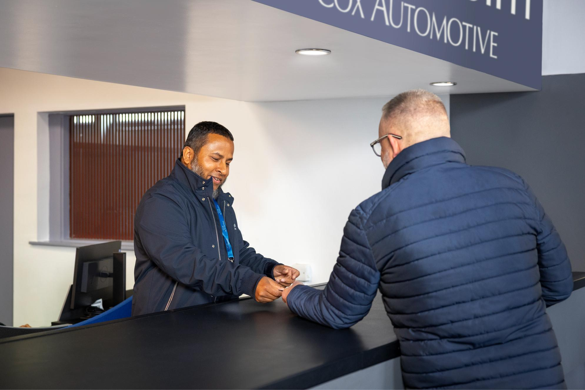 Dealer receiving customer support at Cox Automotive