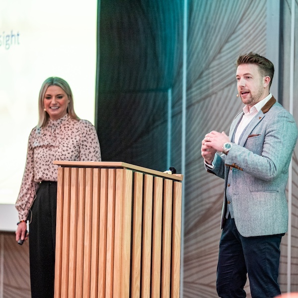 Team members on stage during work event